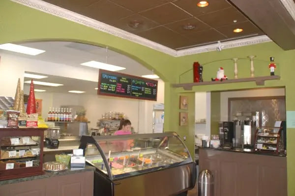 Retail café interior with a refrigerated display case and commercial refrigeration equipment providing reliable front-of-house cooling.